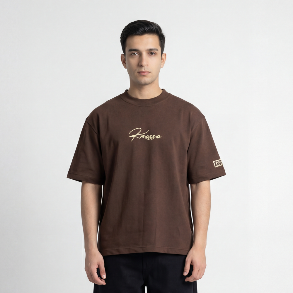 Front view of model wearing Krosso oversized brown t-shirt with embroidered logo and premium oversized fit.