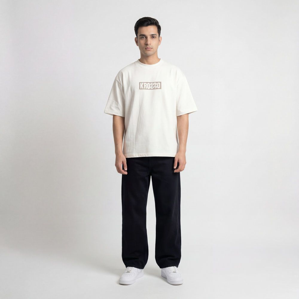 Full body front view of model wearing Krosso oversized antique white t-shirt with minimal logo branding.