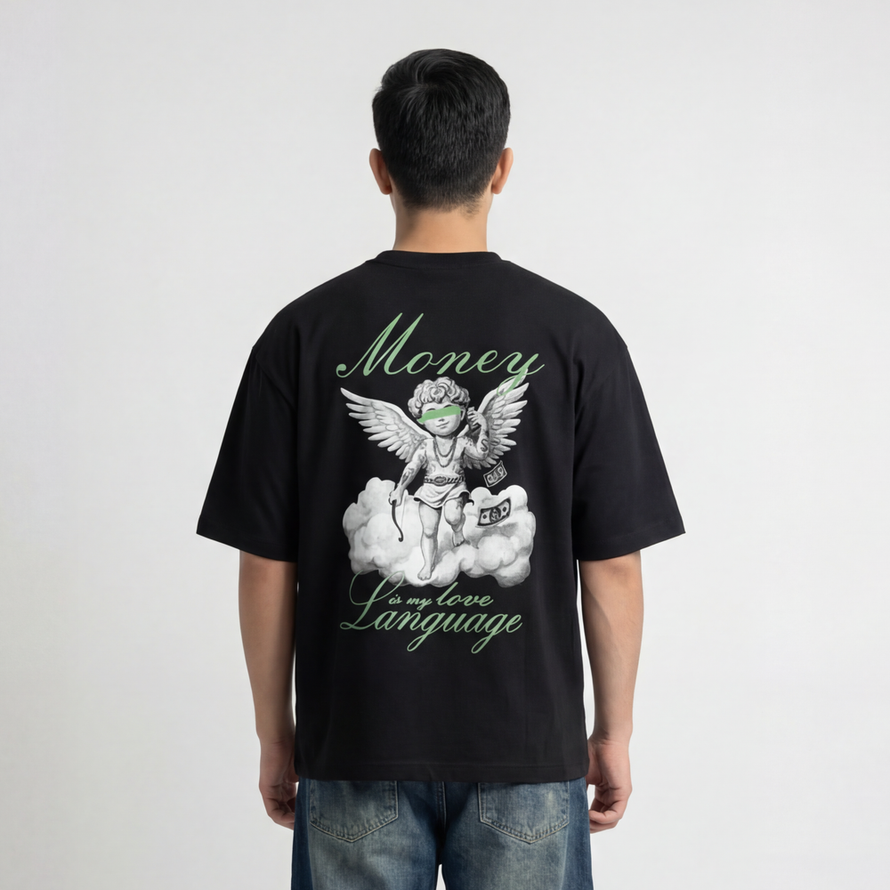 Back view of model wearing Krosso “Money Is My Love Language” oversized black t-shirt with angel graphic and green typography print.