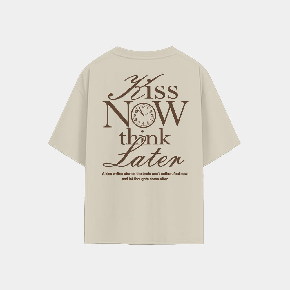 Krosso “Kiss Now Think Later” oversized antique white t-shirt back view with typography design and clock graphic.